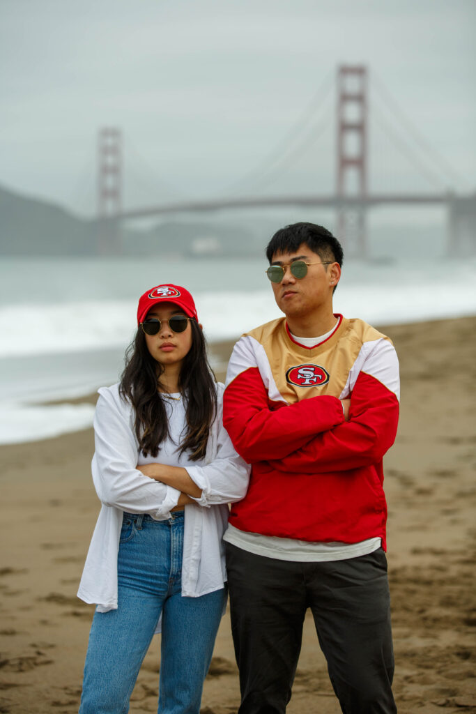 Engagement photo session in 49ers jersey at Baker Beach in San Francisco, California