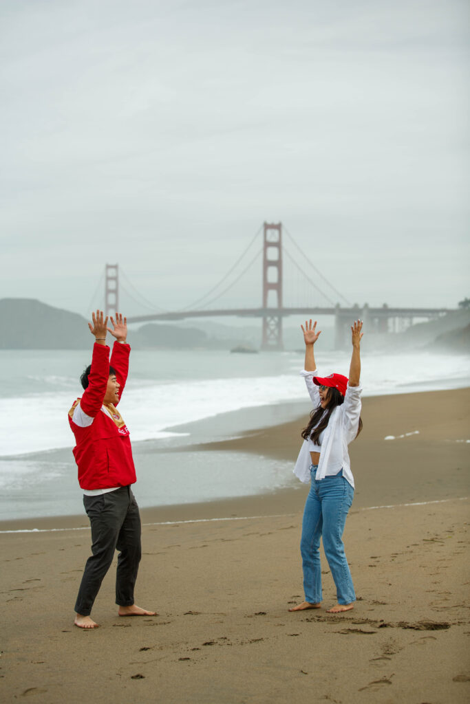Engagement photo session celebrating 49ers at Baker Beach in San Francisco, California