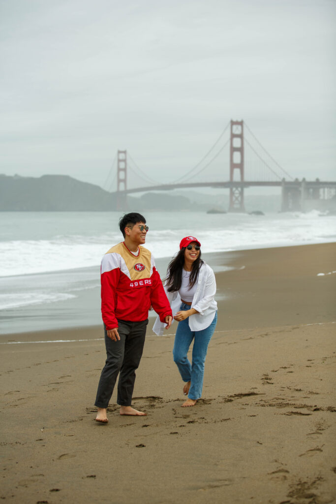 Engagement photo session at Baker Beach in San Francisco, California in 49ers gear.