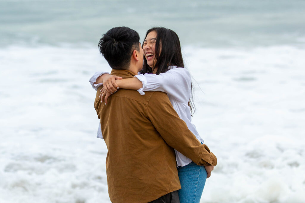 Cute couple engagement photo session at Baker Beach in San Francisco, California