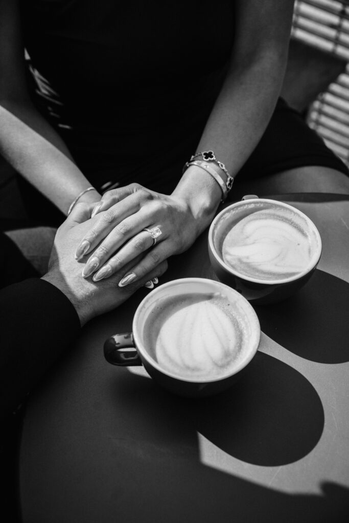 Couple hold hands nexts to coffee in San Francisco