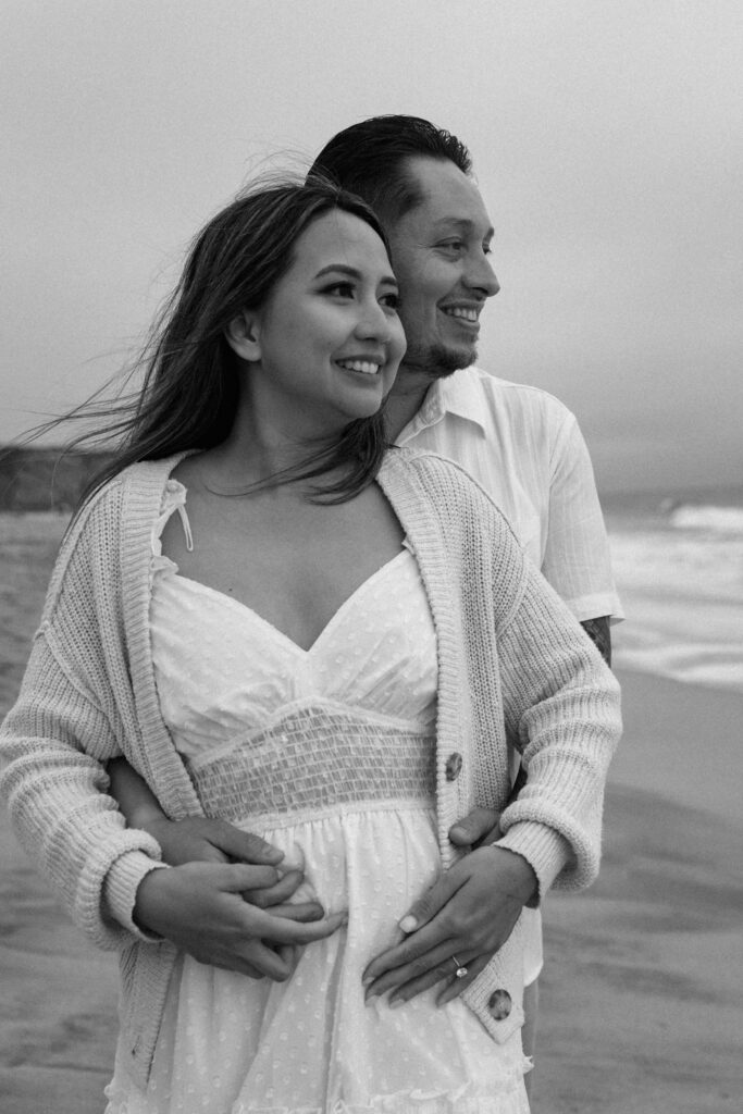 Black and white photo of guy and girl on the beach in California. 